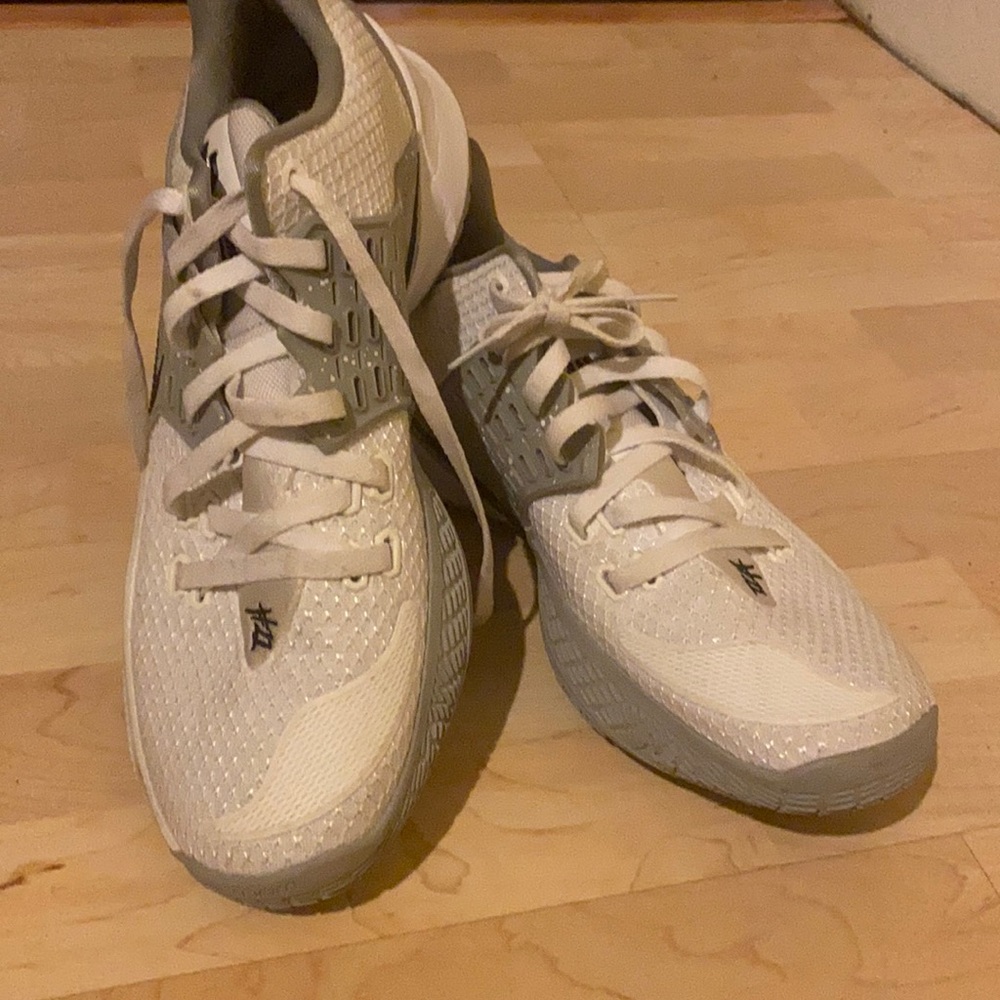 White with gray Kyrie Irving Basketball sneakers.